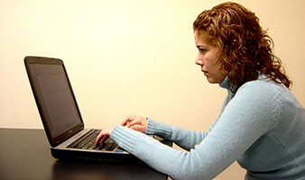 Woman working at laptop.